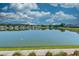 Picturesque pond reflecting homes and blue sky with fluffy clouds at 6972 Pumpkinseed Dr, Johns Island, SC 29455