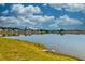 Picturesque view of a tranquil pond surrounded by well-maintained lawns and neighborhood homes at 6972 Pumpkinseed Dr, Johns Island, SC 29455