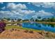 Picturesque pond view featuring a fountain, lush greenery, and beautiful houses in the background at 6972 Pumpkinseed Dr, Johns Island, SC 29455