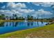 Picturesque pond view featuring a fountain, lush greenery, and beautiful houses in the background at 6972 Pumpkinseed Dr, Johns Island, SC 29455
