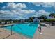 Community pool surrounded by lounge chairs, umbrellas and palm trees at 6972 Pumpkinseed Dr, Johns Island, SC 29455