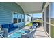 Inviting screened porch featuring comfortable seating and view of the backyard and neighborhood at 6972 Pumpkinseed Dr, Johns Island, SC 29455