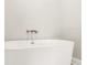 Modern white freestanding bathtub with silver fixtures against a white wall at 709 Oakridge View Trl, Ridgeville, SC 29472