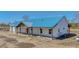 Home featuring long covered porch, white siding, blue roof at 709 Oakridge View Trl, Ridgeville, SC 29472
