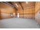 Unfinished spacious garage with open ceiling, concrete floor, and access door at 709 Oakridge View Trl, Ridgeville, SC 29472