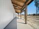 Long covered porch with exposed beam ceiling and ceiling fans at 709 Oakridge View Trl, Ridgeville, SC 29472