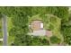 An aerial view of a landscaped property surrounded by lush greenery, including mature trees and manicured lawns at 7879 Gull Bay Dr, Awendaw, SC 29429