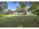 Expansive green backyard featuring mature trees and an overview of the home at 7879 Gull Bay Dr, Awendaw, SC 29429