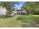 Spacious backyard with a charming home featuring multiple decks overlooking the well-maintained lawn at 7879 Gull Bay Dr, Awendaw, SC 29429