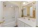Bright bathroom featuring a vanity, bathtub, and an ornate gold-framed mirror with decorative plants at 7879 Gull Bay Dr, Awendaw, SC 29429