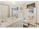 Bright bathroom featuring a neutral color palette, large mirror, and a shower with glass doors at 7879 Gull Bay Dr, Awendaw, SC 29429