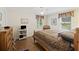 Comfortable bedroom with neutral tones, featuring a ceiling fan and abundant natural light from multiple windows at 7879 Gull Bay Dr, Awendaw, SC 29429