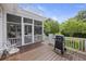 Charming deck featuring a grill and outdoor seating, perfect for enjoying the scenic backyard at 7879 Gull Bay Dr, Awendaw, SC 29429