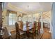 Formal dining room with chandelier, detailed trim, and a staircase view at 7879 Gull Bay Dr, Awendaw, SC 29429