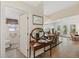 Open-concept entryway with hardwood floors, featuring a view into the living and dining areas at 7879 Gull Bay Dr, Awendaw, SC 29429