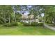 Attractive home with a welcoming front porch and mature trees enhancing curb appeal at 7879 Gull Bay Dr, Awendaw, SC 29429