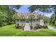 Inviting home with a grand staircase leading to the entrance and well-maintained landscaping at 7879 Gull Bay Dr, Awendaw, SC 29429
