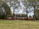 A large home with mature trees and azaleas in the front yard at 7879 Gull Bay Dr, Awendaw, SC 29429