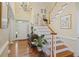Grand foyer with high ceilings, chandelier, hardwood floors, and elegant staircase, creating a welcoming entrance at 7879 Gull Bay Dr, Awendaw, SC 29429