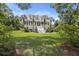 Inviting two-story home framed by lush greenery, showcasing a classic design with a welcoming front porch at 7879 Gull Bay Dr, Awendaw, SC 29429