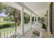 Inviting front porch with rocking chairs and lush greenery, offering a serene outdoor living space at 7879 Gull Bay Dr, Awendaw, SC 29429