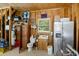 Finished garage with a toilet, sink, and a refrigerator, with storage shelves at 7879 Gull Bay Dr, Awendaw, SC 29429
