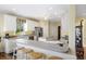Bright kitchen featuring white cabinets, granite countertops, and a breakfast bar with seating at 7879 Gull Bay Dr, Awendaw, SC 29429