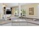 Partial kitchen view showcasing breakfast bar, and the living room in the background at 7879 Gull Bay Dr, Awendaw, SC 29429