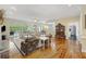 Spacious living room with hardwood floors, comfortable sofa and armchairs, fireplace and view to outside at 7879 Gull Bay Dr, Awendaw, SC 29429