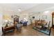 Open living room with neutral walls, ceiling fan and views to the kitchen and dining area at 7879 Gull Bay Dr, Awendaw, SC 29429