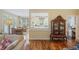 Cozy living area with hardwood floors, a curio cabinet, and a view of the breakfast nook at 7879 Gull Bay Dr, Awendaw, SC 29429
