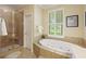 Spa-like bathroom with glass shower and a separate soaking tub, creating a relaxing retreat at 7879 Gull Bay Dr, Awendaw, SC 29429