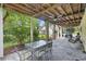 Relaxing covered patio with ceiling fan and outdoor seating area, ideal for enjoying the backyard view at 7879 Gull Bay Dr, Awendaw, SC 29429