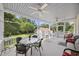 Inviting screened porch with ample seating, ideal for entertaining and enjoying the outdoors at 7879 Gull Bay Dr, Awendaw, SC 29429