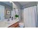 Clean bathroom with a shower and tub combo featuring a white shower curtain and decor at 8938 Planters Row Ln, Summerville, SC 29485