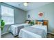 Bright bedroom with two twin beds, stylish bedding, and plenty of natural light at 8938 Planters Row Ln, Summerville, SC 29485