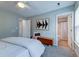 Well-lit bedroom showcases neutral walls, an area rug, and an upholstered bench at 8938 Planters Row Ln, Summerville, SC 29485