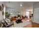 Spacious living room with a unique leather sofa, decorative rug, and plants at 8938 Planters Row Ln, Summerville, SC 29485