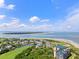Scenic aerial view showcasing the beautiful community with ocean views, golf course, and condo building at 9002 Palmetto Dr # 420, Isle of Palms, SC 29451