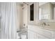 Bathroom featuring a shower with curtain, a clean toilet, and a vanity with a framed mirror at 9002 Palmetto Dr # 420, Isle of Palms, SC 29451