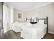 Inviting bedroom featuring two beds, complemented by a shuttered window and neutral decor at 9002 Palmetto Dr # 420, Isle of Palms, SC 29451