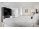 Comfortable bedroom featuring two beds, shuttered window, and a dark wood entertainment center at 9002 Palmetto Dr # 420, Isle of Palms, SC 29451