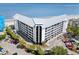 A view of the building from the parking lot looking towards the beach with palm trees and balconies at 9002 Palmetto Dr # 420, Isle of Palms, SC 29451