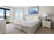 Bright main bedroom featuring plantation shutters and balcony with beach views at 9002 Palmetto Dr # 420, Isle of Palms, SC 29451
