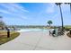 Beautiful large pool and patio surrounded by lounge chairs, palm trees, and landscaping with ocean views at 9002 Palmetto Dr # 420, Isle of Palms, SC 29451