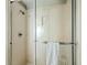 Clean shower showcasing a glass door, towel bar, and convenient built-in storage at 9002 Palmetto Dr # 420, Isle of Palms, SC 29451