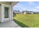 Exterior view of the backyard area with green grass and other homes in the background at 913 Dusk Dr, Summerville, SC 29486