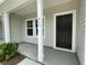 Front porch view of black front door, house number on column, and vinyl siding at 913 Dusk Dr, Summerville, SC 29486