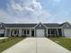 Charming townhome with a well-manicured lawn and a long driveway leading to the attached garage at 913 Dusk Dr, Summerville, SC 29486