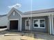 New construction home with visible framing for the garage, light gray siding and white trim at 913 Dusk Dr, Summerville, SC 29486
